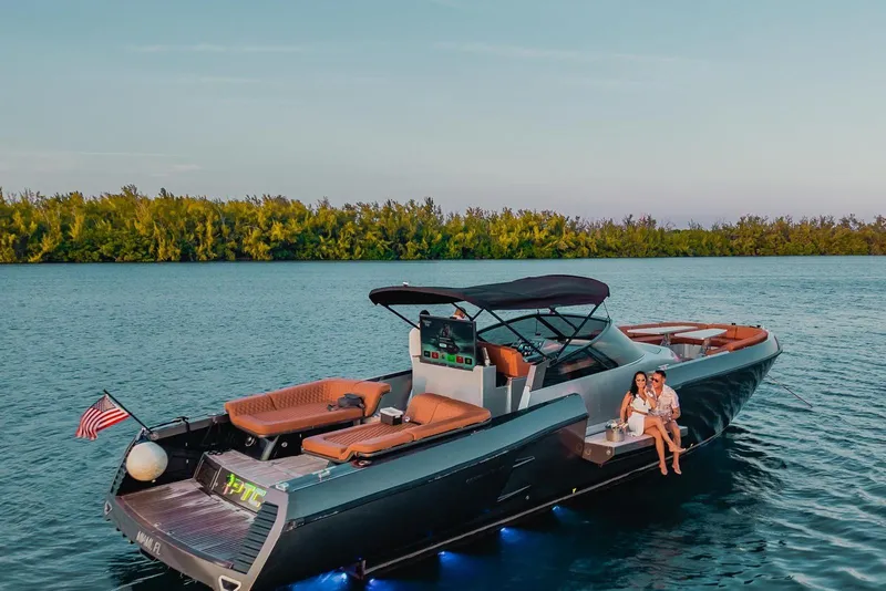 Slide: The Image of Luxury CNM Continental yacht on serene water, 2015 model, with couple enjoying sunset. - 53