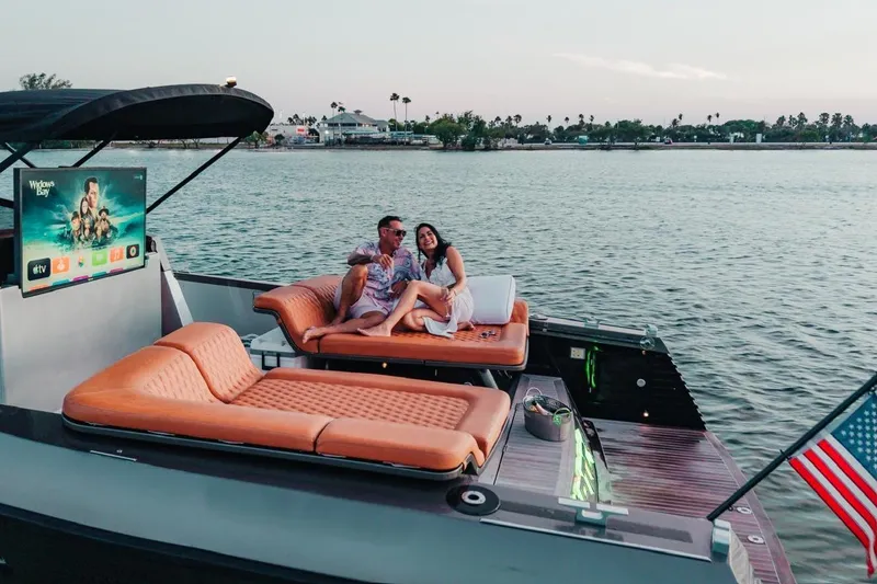 Slide: The Image of Couple relaxing on a 2015 CNM Continental yacht with a TV, near a scenic shoreline. - 54