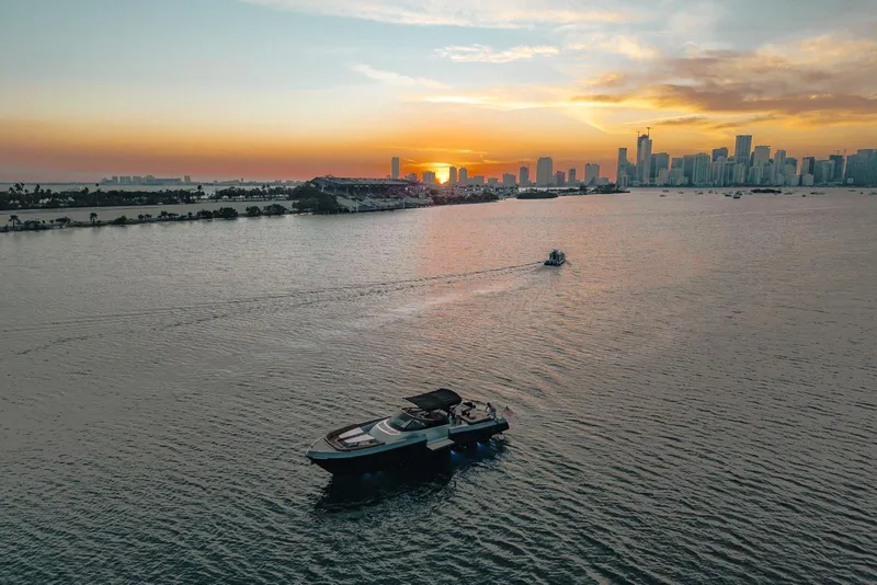 Slide: The Image of A CNM Continental yacht cruising at sunset near a city skyline, 2015 model. - 55