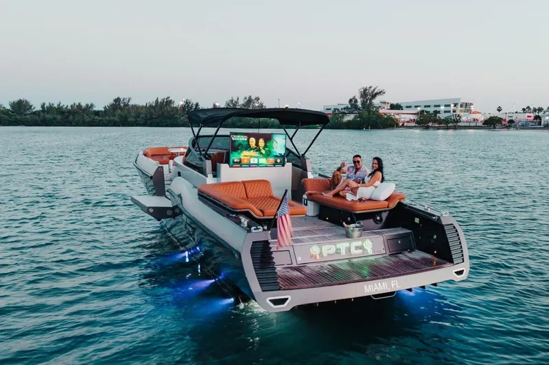 Slide: The Image of Luxurious 2015 CNM Continental yacht with lounging couple, Miami waters, evening ambiance. - 57