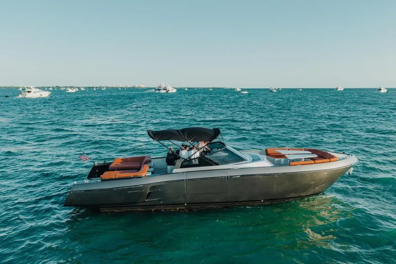 Slide: The Image of Luxury CNM Continental 2015 yacht cruising on open sea with multiple boats in background. - 58