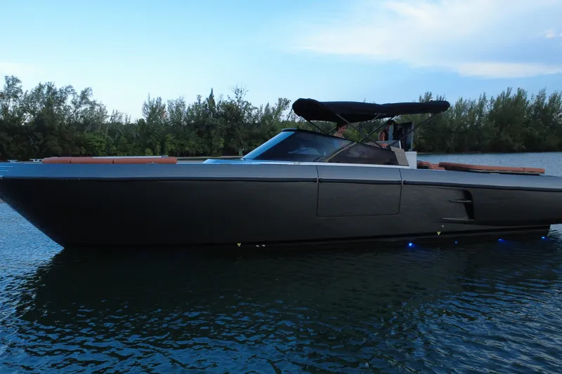 Slide: The Image of Luxury CNM Continental 2015 yacht on serene water with lush greenery backdrop. - 9
