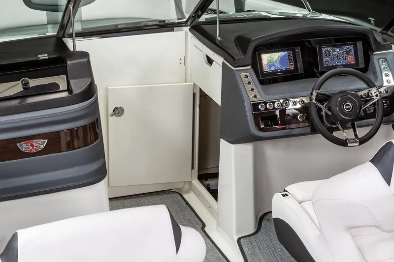 Slide: The Image of Manufacturer Provided Image: 2021 Chaparral 307 SSX boat interior with modern dashboard and navigation system. - 12