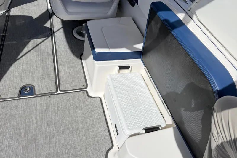 Slide: The Image of 2021 Chaparral 307 SSX boat interior with seating and storage area. - 6