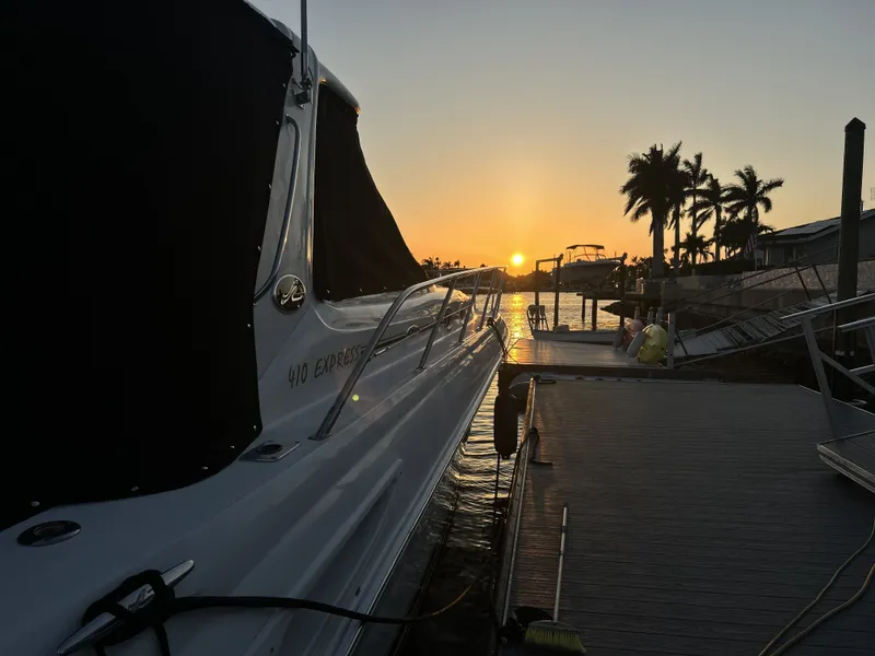 The Image of 2003 Sea Ray 410 Express Cruiser at sunset by the dock. - 0