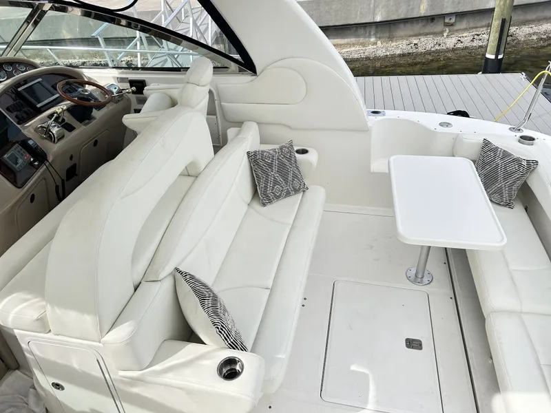 Slide: The Image of Interior of a 2003 Sea Ray 410 Express Cruiser with white seating. - 17