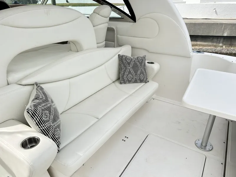 Slide: The Image of Interior of a 2003 Sea Ray 410 Express Cruiser with white seating. - 18