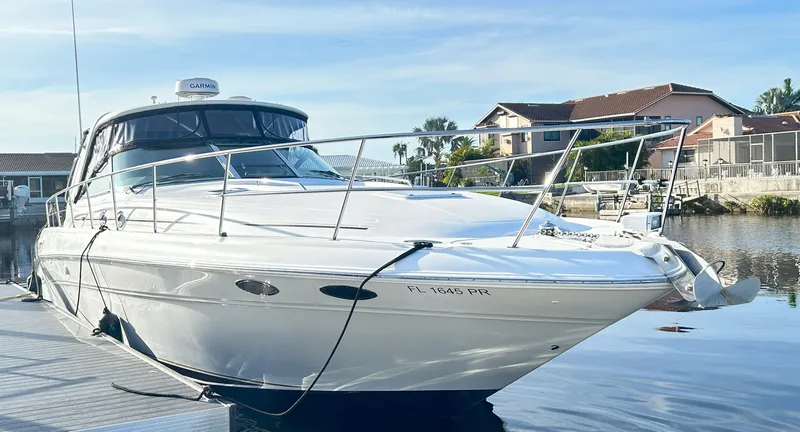 Slide: The Image of 2003 Sea Ray 410 Express Cruiser docked on a sunny day. - 2