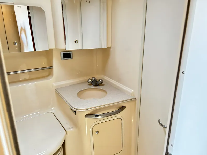 Slide: The Image of 2003 Sea Ray 410 Express Cruiser bathroom with sink and storage. - 28