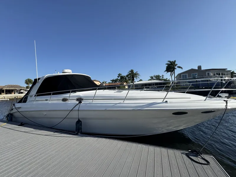 Slide: The Image of 2003 Sea Ray 410 Express Cruiser docked on a sunny day. - 3