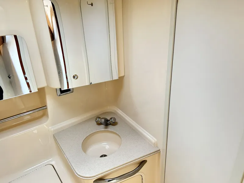 Slide: The Image of Bathroom in 2003 Sea Ray 410 Express Cruiser, featuring sink and mirror. - 30