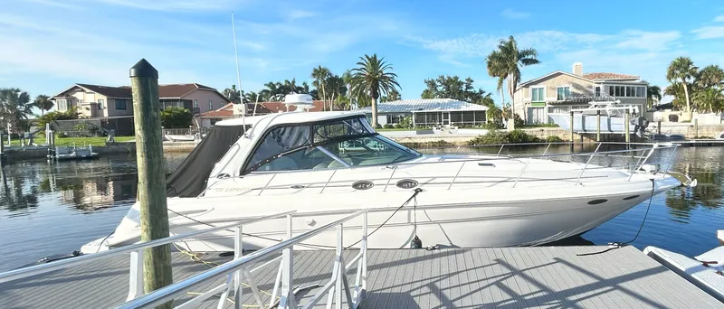 Slide: The Image of 2003 Sea Ray 410 Express Cruiser docked on a sunny day. - 4