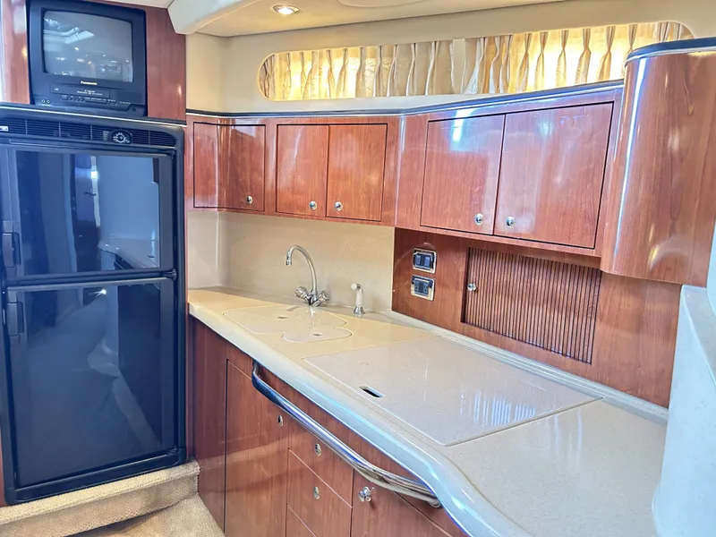 Slide: The Image of Interior of 2003 Sea Ray 410 Express Cruiser with kitchen area. - 42
