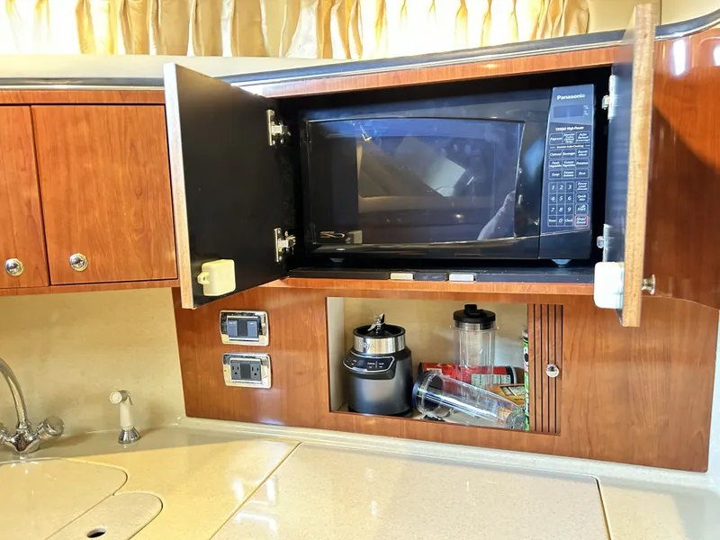 Slide: The Image of Kitchen area in a 2003 Sea Ray 410 Express Cruiser with microwave. - 44