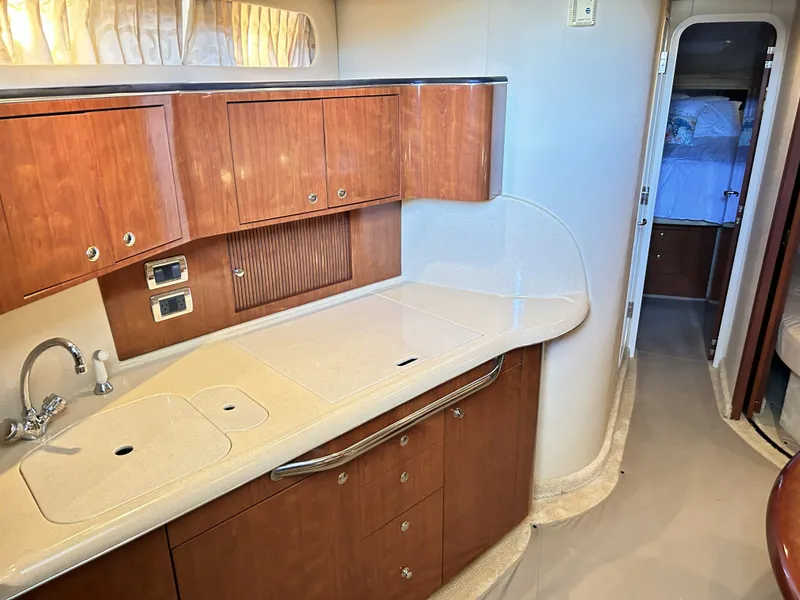 Slide: The Image of Interior of 2003 Sea Ray 410 Express Cruiser with elegant kitchen. - 47