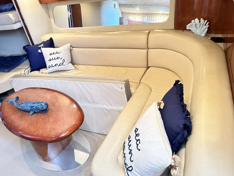 Slide: The Image of Interior of 2003 Sea Ray 410 Express Cruiser with beige sofa and pillows. - 48
