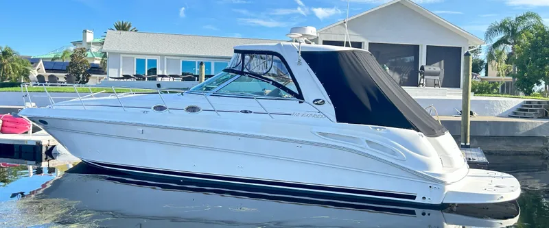 Slide: The Image of 2003 Sea Ray 410 Express Cruiser docked in front of a house. - 7