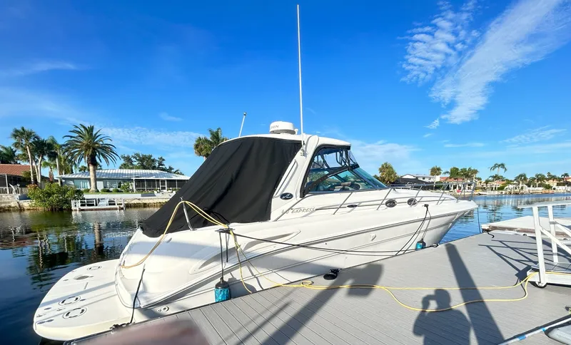 Slide: The Image of 2003 Sea Ray 410 Express Cruiser docked on a sunny day. - 8