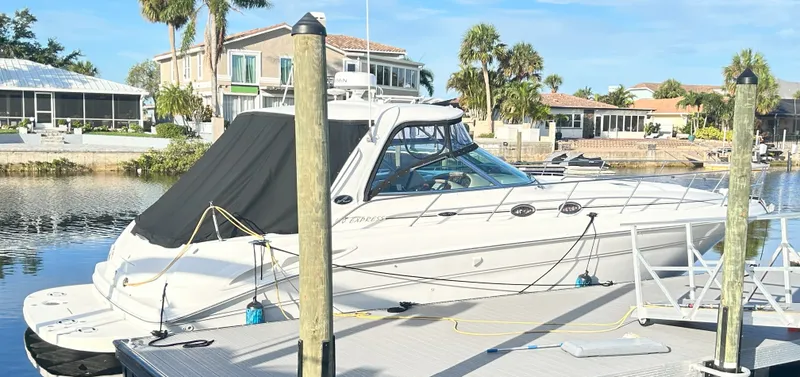 Slide: The Image of 2003 Sea Ray 410 Express Cruiser docked on a sunny day. - 9