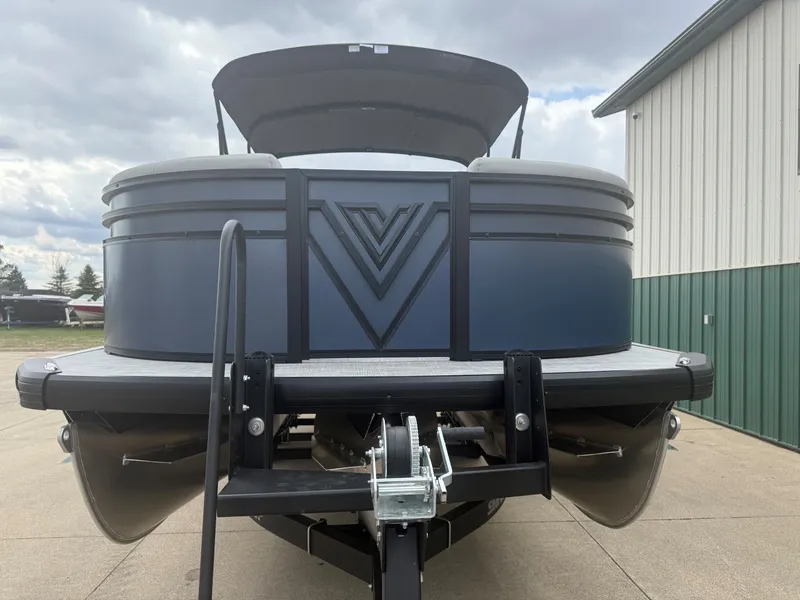 Slide: The Image of Viaggio Lago V 20C 2026 pontoon boat on trailer in front of building. - 5