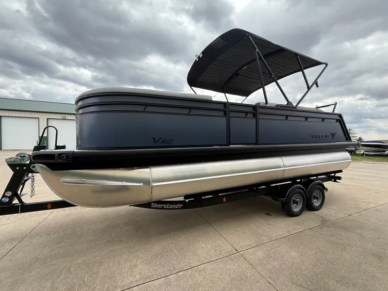 Slide: The Image of Viaggio Lago V 20C 2026 pontoon boat on trailer, cloudy sky. - 6