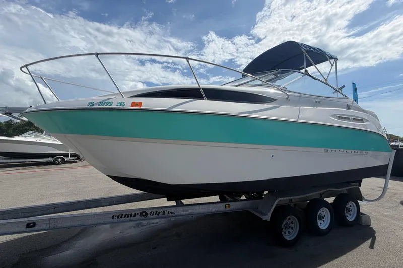 Slide: The Image of 2004 Bayliner 2452 Ciera Express boat on trailer under a sunny sky. - 10