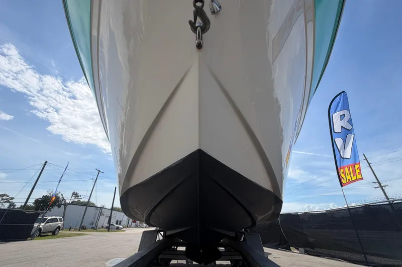 Slide: The Image of 2004 Bayliner 2452 Ciera Express boat on trailer, RV sale banner visible. - 12