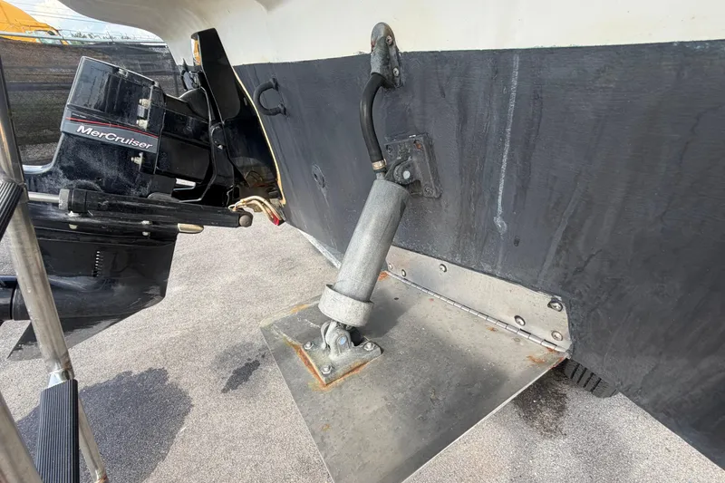 Slide: The Image of 2004 Bayliner 2452 Ciera Express with MerCruiser engine and trim tab detail. - 3