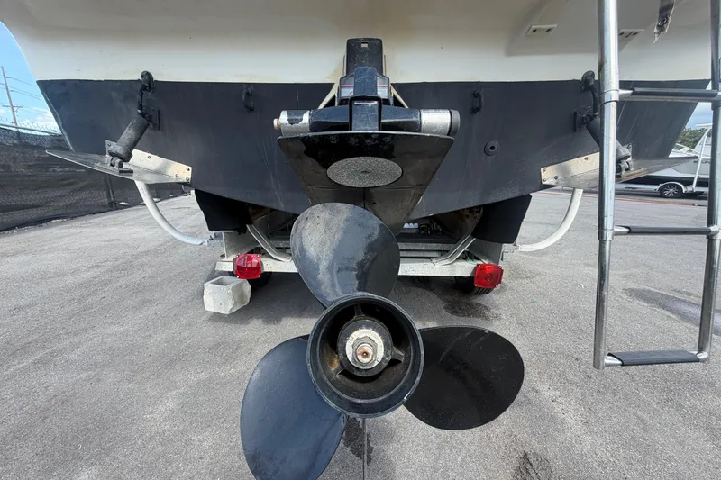 Slide: The Image of Rear view of a 2004 Bayliner 2452 Ciera Express boat with visible propeller and ladder. - 6
