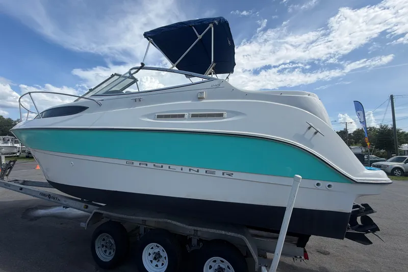 Slide: The Image of 2004 Bayliner 2452 Ciera Express boat on trailer under blue sky. - 8