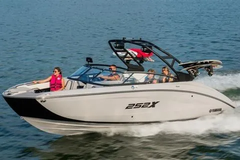 Slide: The Image of 2026 Yamaha 252XE boat cruising on water with passengers enjoying the ride. - 8