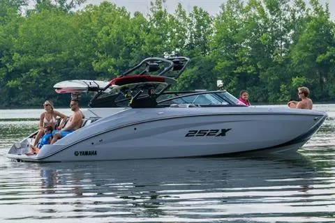 Slide: The Image of 2026 Yamaha 252XE boat on a lake with people enjoying a sunny day. - 9