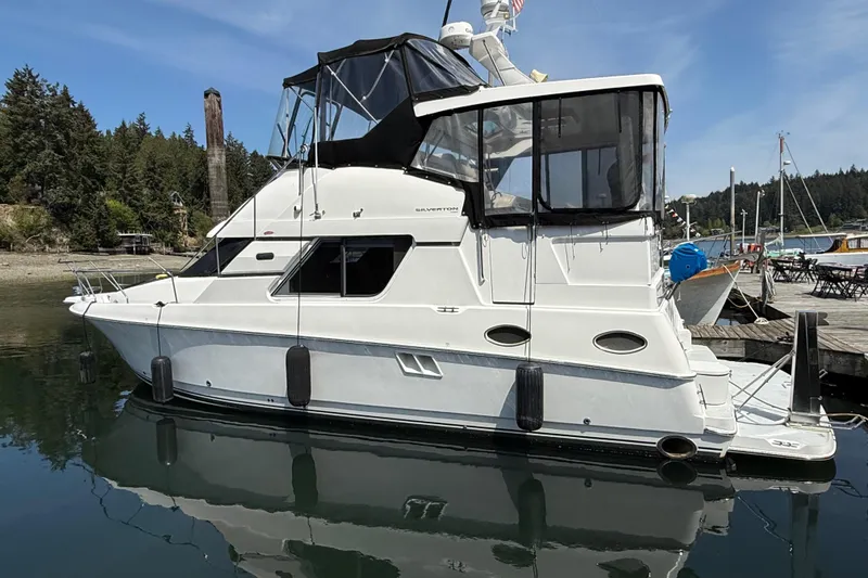 The Image of 1998 Silverton 372 Motor Yacht docked in a serene marina setting. - 0