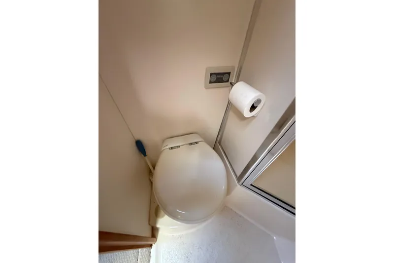 Slide: The Image of 1998 Silverton 372 Motor Yacht bathroom with toilet and shower area. - 13