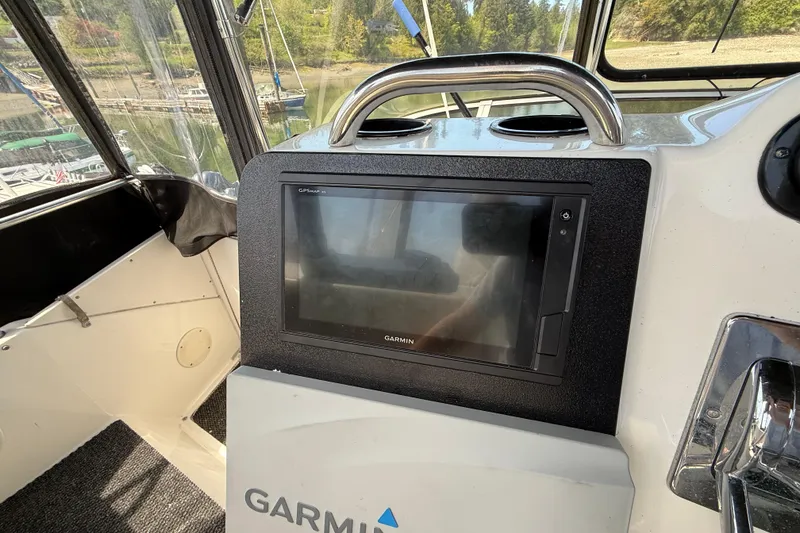 Slide: The Image of Garmin GPS system on 1998 Silverton 372 Motor Yacht dashboard, with marina view. - 14
