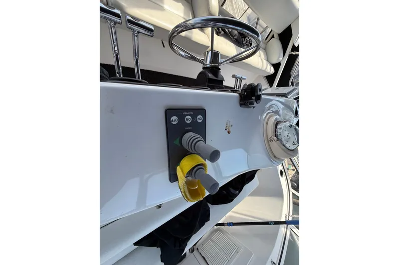 Slide: The Image of 1998 Silverton 372 Motor Yacht helm with steering wheel and control panel. - 16