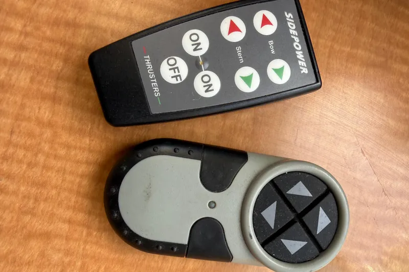 Slide: The Image of Remote controls for 1998 Silverton 372 Motor Yacht thrusters on wooden surface. - 17