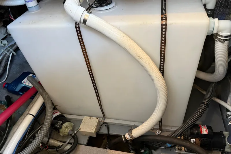 Slide: The Image of Engine room of a 1998 Silverton 372 Motor Yacht with hoses and equipment. - 20