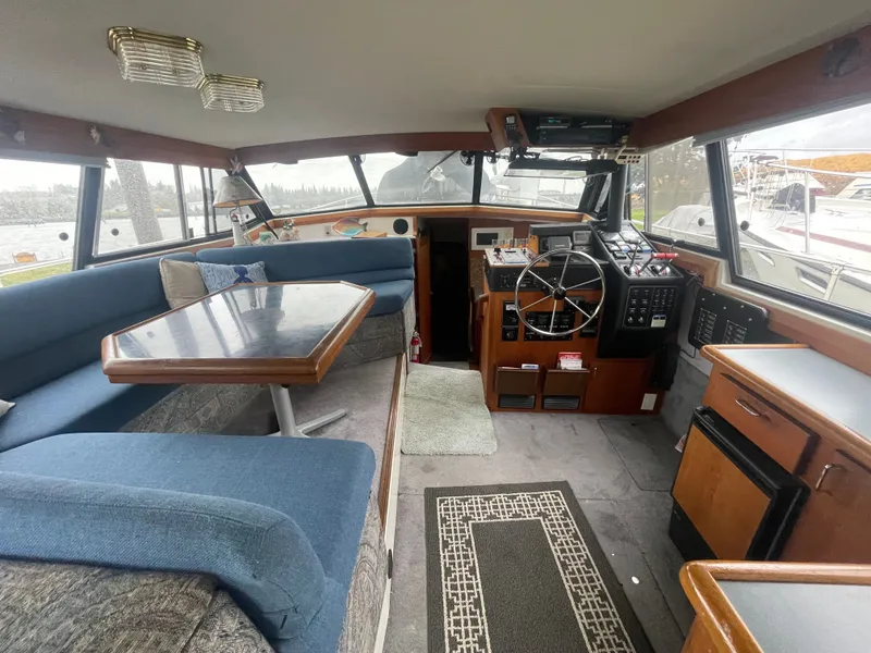 Slide: The Image of Interior of a 1992 Bayliner 38 Motoryacht with helm and seating area. - 14