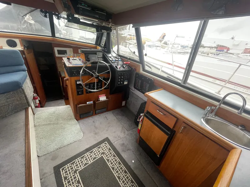 Slide: The Image of Interior of a 1992 Bayliner 38 Motoryacht with helm and kitchenette. - 15