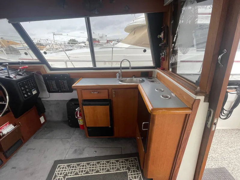 Slide: The Image of Interior of 1992 Bayliner 38 Motoryacht with helm and kitchenette. - 16
