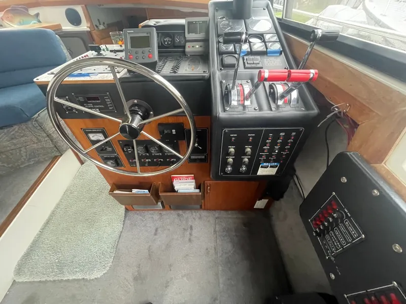 Slide: The Image of 1992 Bayliner 38 Motoryacht cockpit with steering wheel and controls. - 18