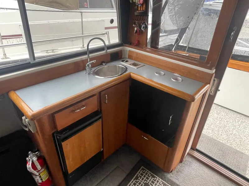 Slide: The Image of 1992 Bayliner 38 Motoryacht kitchen area with sink and cabinets. - 23