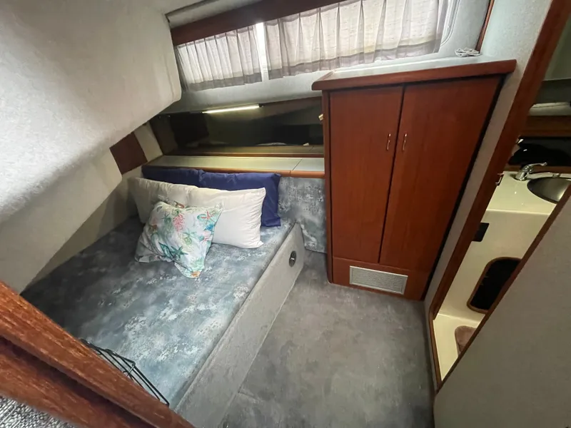 Slide: The Image of 1992 Bayliner 38 Motoryacht interior with bed and cabinet. - 28