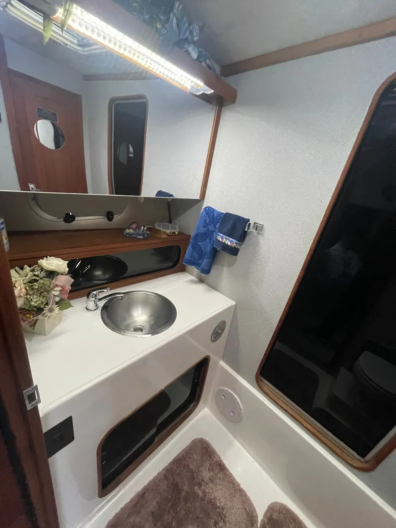 Slide: The Image of 1992 Bayliner 38 Motoryacht bathroom with sink and mirror. - 30