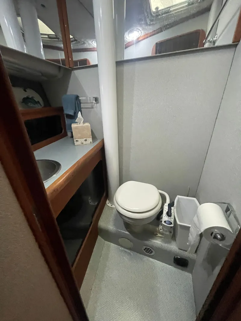 Slide: The Image of 1992 Bayliner 38 Motoryacht bathroom with toilet and sink. - 32