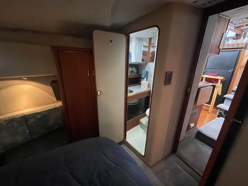 Slide: The Image of Interior of 1992 Bayliner 38 Motoryacht featuring bedroom and bathroom. - 38