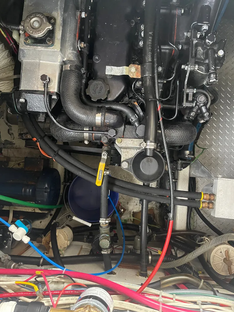 Slide: The Image of Engine room of a 1992 Bayliner 38 Motoryacht with hoses and valves. - 42