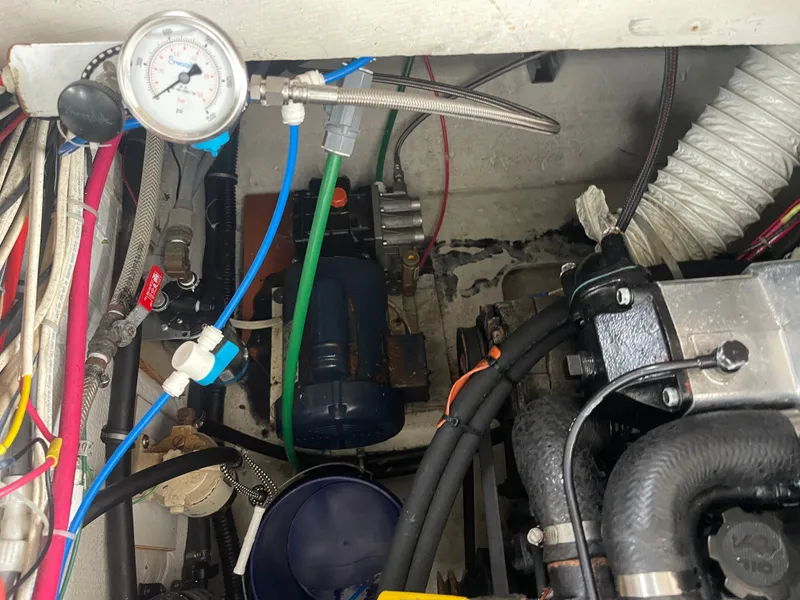 Slide: The Image of Engine room of 1992 Bayliner 38 Motoryacht with hoses and pressure gauge. - 44