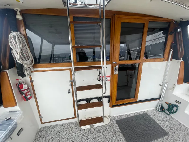 Slide: The Image of Interior of a 1992 Bayliner 38 Motoryacht with wood accents and ladder. - 5